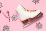 Ice skate with decorative snowflakes and candy canes on pink background