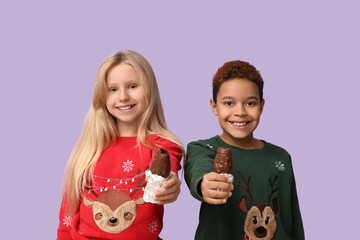 Poster - Cute little children with chocolate Santa Claus on lilac background