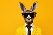 Portrait of a donkey in a business suit on a yellow background