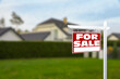 Sale sign near beautiful house outdoors. Red signboard with words