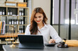 © Nuttapong punna - Beautiful asian woman lawyer working and gavel, tablet, laptop in front, Advice justice and law concept.