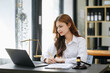 © Nuttapong punna - Beautiful asian woman lawyer working and gavel, tablet, laptop in front, Advice justice and law concept.