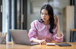 © David - Portrait of tired young business Asian woman work with documents tax laptop computer in office. Sad, unhappy, Worried, Depression, or employee life stress concept