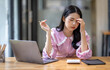 © David - Portrait of tired young business Asian woman work with documents tax laptop computer in office. Sad, unhappy, Worried, Depression, or employee life stress concept