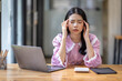 © David - Portrait of tired young business Asian woman work with documents tax laptop computer in office. Sad, unhappy, Worried, Depression, or employee life stress concept