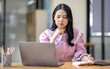 © David - Portrait of tired young business Asian woman work with documents tax laptop computer in office. Sad, unhappy, Worried, Depression, or employee life stress concept