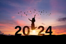 Young Woman Enjoying And Celebrating New Year 2024 With The Beautiful Sunrise Sky And Landscape
