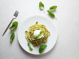 Canvas Print - Basil pasta with burrata cheese on a plate	