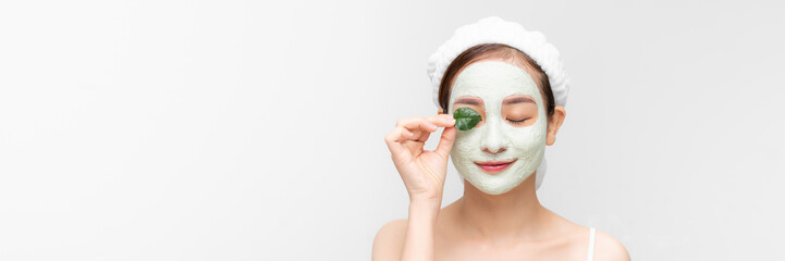 Wall Mural - Banner with young woman with clay face mask - natural spa, beauty from nature concept