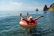 © svetograph - Summer vacation woman in hat floats on an inflatable donut mattress. Happy woman relaxing and enjoying family summer travel holidays travel on the sea.