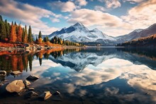 A Crystal-clear Mountain Lake Reflecting A Pristine, Cloud-streaked Sky On A Crisp Fall Morning