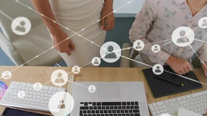 Wall Mural - Animation of network of connections with icons over diverse business people in office