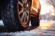 A close-up view of a tire on a snowy road. Perfect for illustrating winter driving conditions
