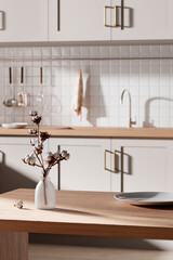 Wall Mural - A bright beige-toned kitchen interior with sunlight 
coming through the window.