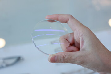 Canvas Print - hand holding a eyeglasses lenses 