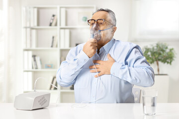 Mature man with chest pain using a nebulizer