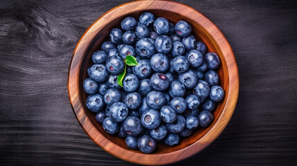 Wall Mural - Fresh blueberry with drops of water in wooden bowl. Top view. Concept of healthy. generative ai