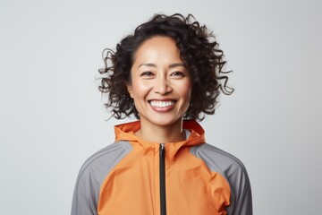 Wall Mural - Portrait of a content asian woman in her 40s sporting a breathable mesh jersey against a white background. AI Generation