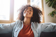 © Chebix - Happy African American woman relaxing on sofa at home.Smiling girl enjoying the day off on the sofa.
