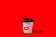 © ADDICTIVE STOCK - Disposable coffee cup with lipstick mark on red background