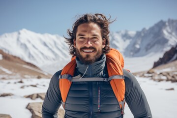 Wall Mural - Portrait of a satisfied man in his 30s wearing a lightweight running vest against a pristine snowy mountain. AI Generation
