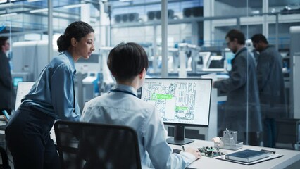 Fototapete - Hispanic Female Supervisor And Asian Male Engineer Talking And Using Desktop Computer With Blueprint Of Printed Circuit Board, While Indian Assembly Line Worker Using Soldering Jet Printer At Factory.