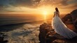 Woman in white gown admiring the sea at sunset from cliff top