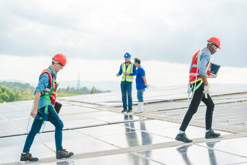 Wall Mural - Technician engineer service meeting and checking solar cell on rooftop of industrial factory. Inspection worker repair solar cell panels. Clean Renewable energy, Ecology and alternative power concept