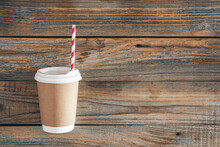 Paper Cup And Straw For Drinks On A Wooden Background.