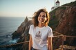 © Markus Schröder - Portrait of a joyful woman in her 20s sporting a vintage band t-shirt against a majestic lighthouse on a cliff background. AI Generation
