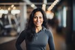 © Markus Schröder - Portrait of a glad indian woman in her 40s wearing a classic turtleneck sweater against a dynamic fitness gym background. AI Generation
