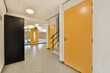 © ADDICTIVE STOCK - Office building with long hallway and yellow doors