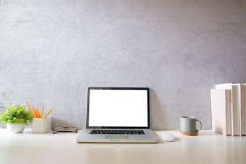Wall Mural - Laptop computer, coffee cup, potted plant and picture frame on creative workplace. Blank screen for your advertising text.