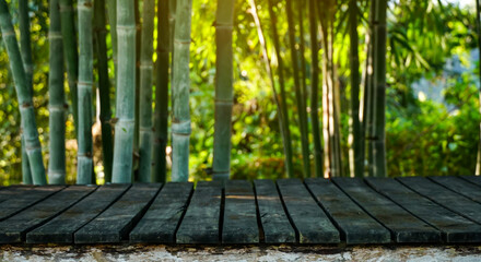 Wall Mural - Empty old wood plank with natural bamboo forest background for product montage.Horizontal.
