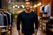 Modern Vlogging Vibes: Black Long Sleeve T-Shirt Mockup Image, Featuring a Stylish Vlogger Posing at the Entrance of a Premium Clothing Boutique