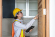 © Supachai - Woman construction engineer using tablet inspect wooden door in building site place. Female architect working at construction site