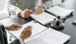 © Charlie's - Lawyer Legal counsel presents to the client a signed contract with gavel and legal law. justice and lawyer Business partnership meeting concept