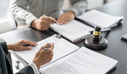 Wall Mural - Lawyer Legal counsel presents to the client a signed contract with gavel and legal law. justice and lawyer Business partnership meeting concept