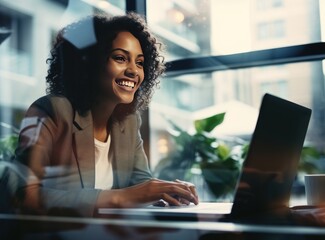 happy businesswoman working on laptop in office with colleagues 
