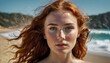  a close up of a woman with frizz on her face and red hair on a beach near the ocean.