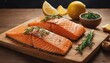  two raw salmon fillets on a cutting board with lemons, garlic, and a sprig of rosemary.