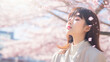 © Natalia - Cute Japanese girl at sakura blooming garden