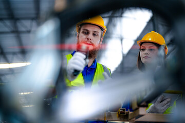 technician engineers team checking the machine and maintenance service. workers looking at the spare parts in the stock at the warehouse. labors with a checklist.