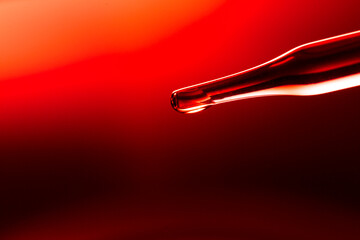Wall Mural - macro science experiment, water drops, liquid dripping from glass pipette in red laboratory