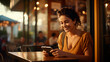 woman smiling with a cell phone in a cafe