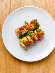 Wall Mural - Tasty and beautiful sushi plate from the best sushi restaurant, the concept. Sushi rolls with rice and fish, soy sauce on a wooden table background. Overhead shot of Japanese seafood sushi set. 