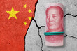 One hundred yuan note on a cracked concrete background. China finance, real estate and debt crisis. China economic collapse