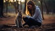 A kangaroo is being played with by a woman on the reserve.