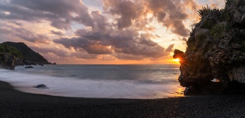 Canvas Print - view of the Marina di Maratea beach at sunset with a sunburst