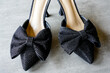 Black heeled sexy backless slip-on mules with a bow and glitters, pleasure shoes